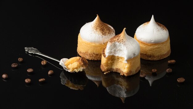 High angle of desserts with powdered cocoa and spoon