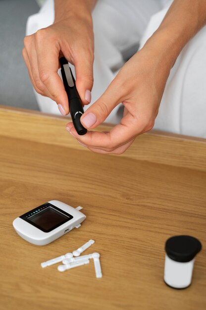 High angle diabetic woman checking her glucose level