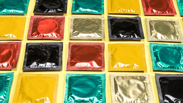 Free photo high angle different coloured wrapped condoms