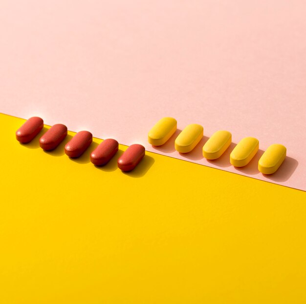 High angle of differently colored pills in rows