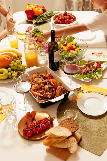 High angle of dishes with wine at dinner table