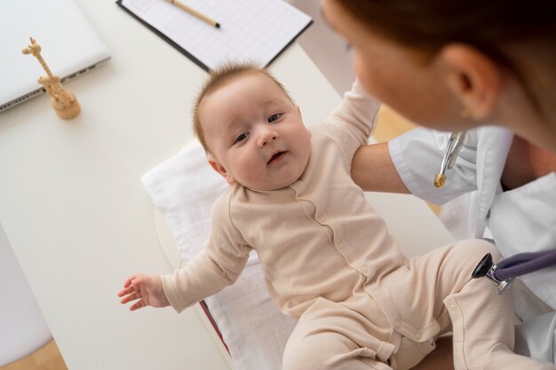 High angle doctor holding baby