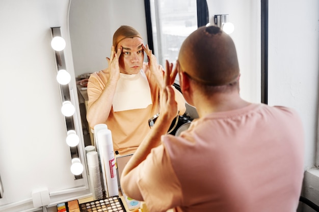 High angle drag queen looking in the mirror