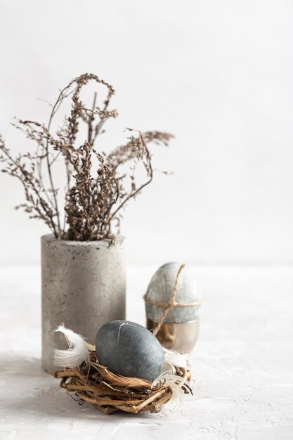 High Angle Of Easter Egg In Bird Nest With Vase Of Flowers