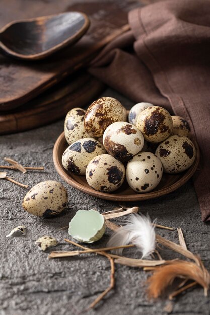 High angle of easter eggs on plate with fabric and wooden spoon