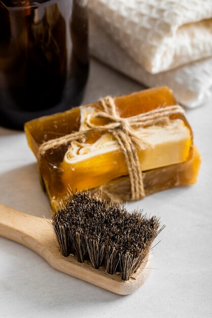 High angle of eco-friendly cleaning products with soaps and brush