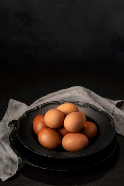 High angle eggs in bowl with kitchen towel and copy-space