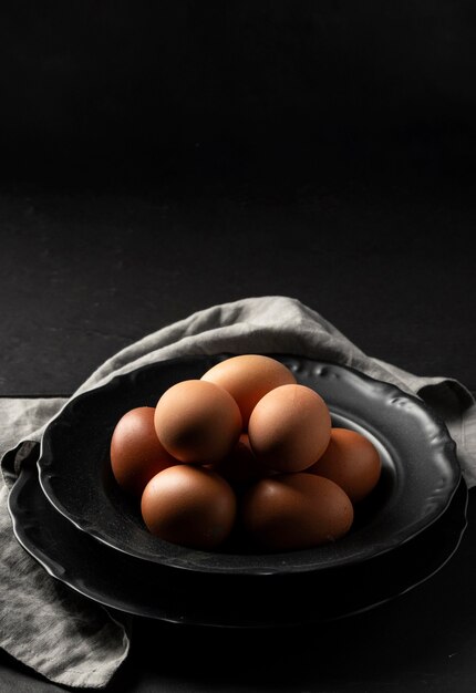 High angle eggs on plate with kitchen towel and copy-space