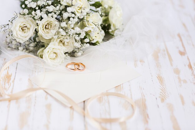 High angle engagement rings beside flowers