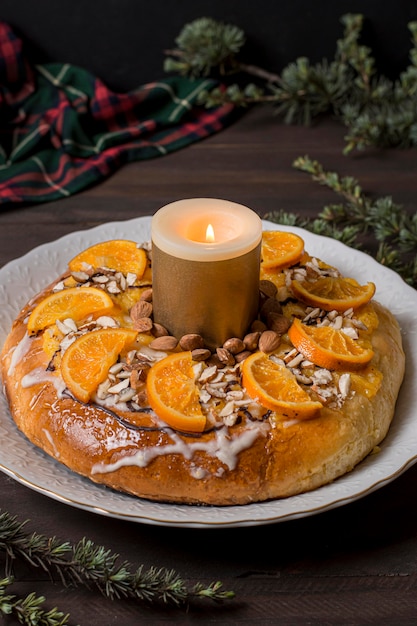 High angle epiphany day food with sliced oranges with lit candle