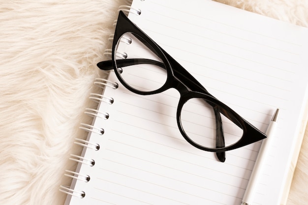 High angle eyeglasses on a notebook