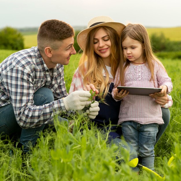 High angle family at farm with tablet