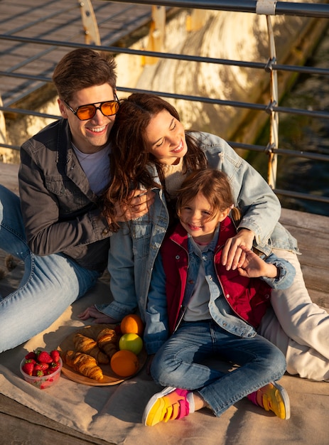 High angle family hanging out on a jetty