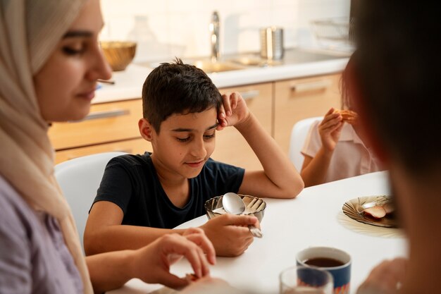 High angle family sitting at table