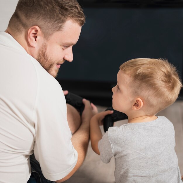 High angle father teaching son games