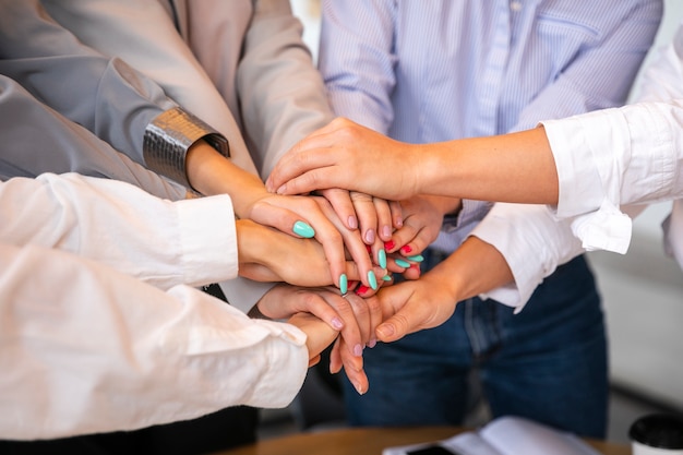 High angle female celebrating with hands stack