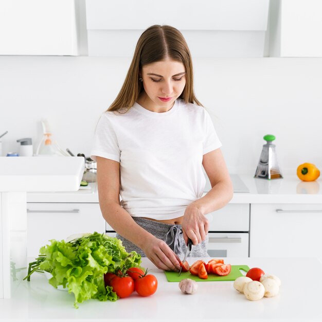 High angle female cutting vegetables