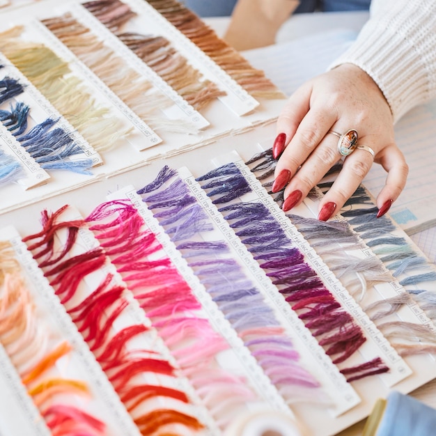 High angle of female fashion designer working in atelier with color palette