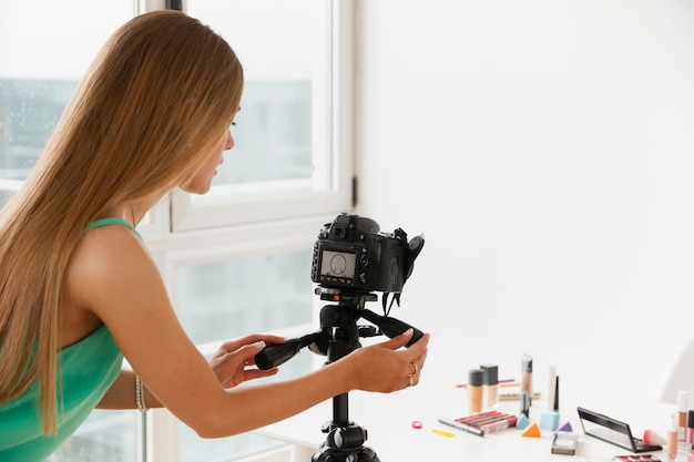 High angle female filming makeup products