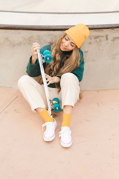 High angle female looking at skateboard