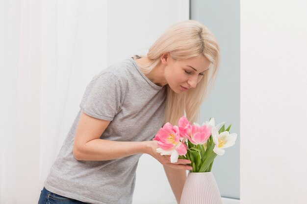 High angle female smelling flowers