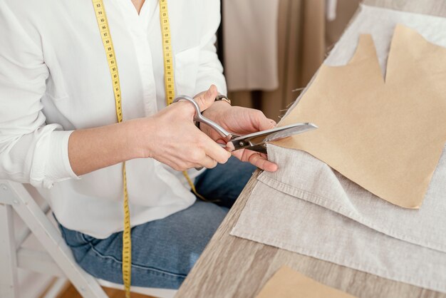 High angle of female tailor working in the studio