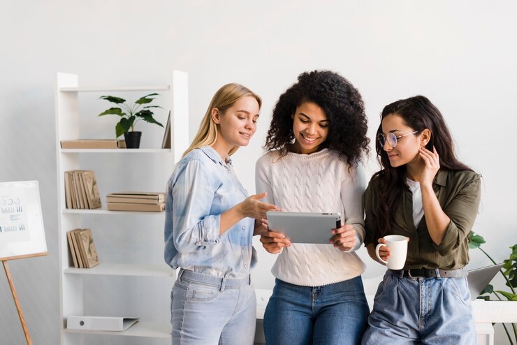 Free Photo high angle females looking on tablet