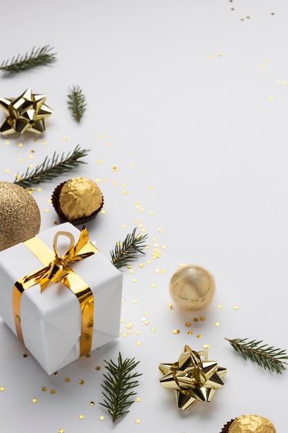 Christmas flat lay. Stylish christmas gift wrapped in gold paper and green  ribbon. Merry Christmas Stock Photo by Sonyachny