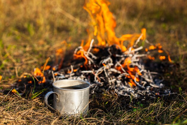 High angle fire with flames and cup beside