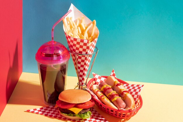 High angle food arrangement with juice cup and cheeseburger