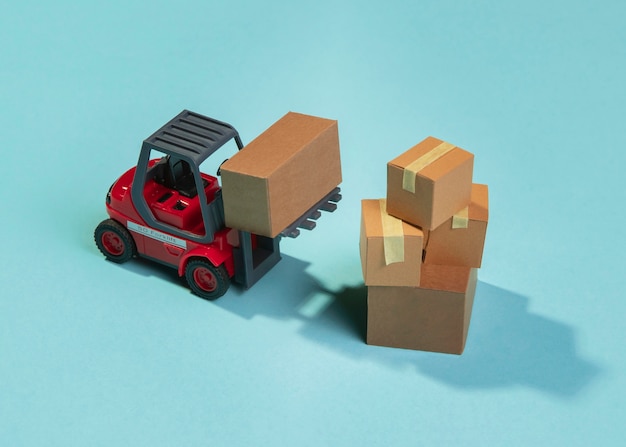 Free photo high angle forklift and boxes arrangement