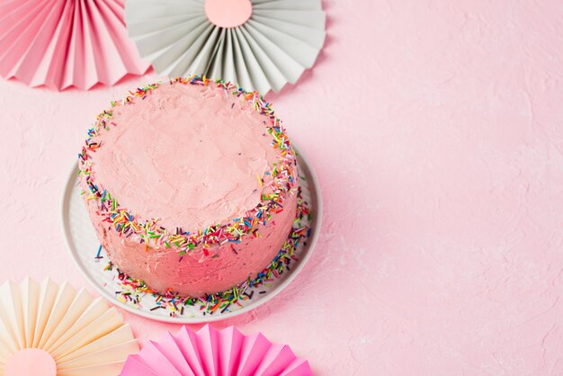 High angle frame with pink cake and copy-space