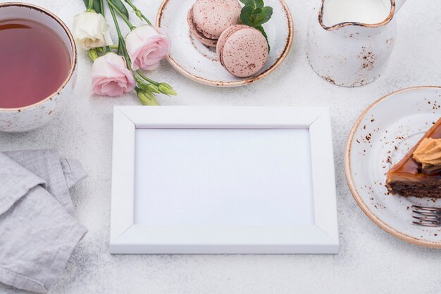 High angle of frame with tea and macarons