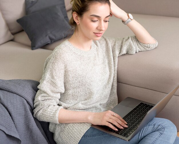 High angle freelance woman on couch working