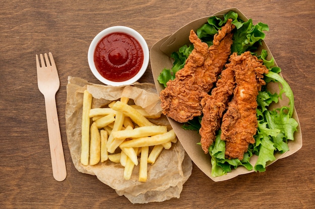 High angle fried chicken and fries with ketchup