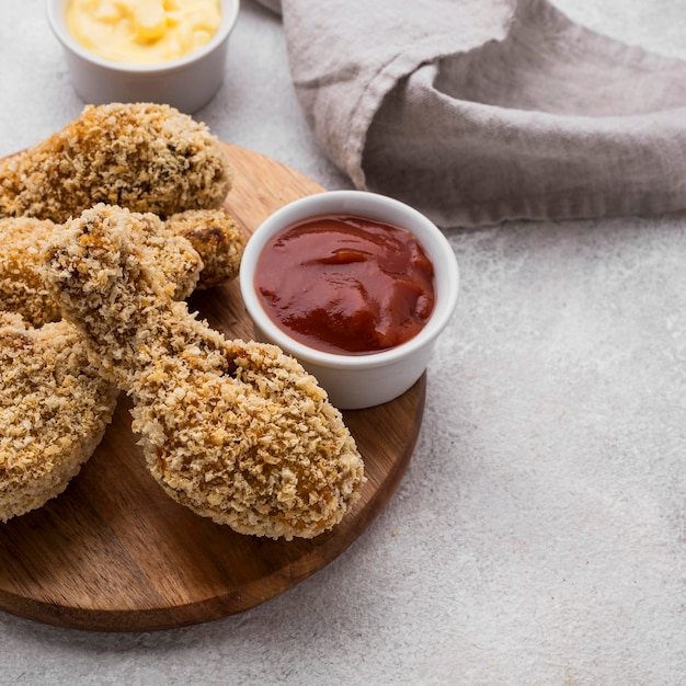 High angle of fried chicken legs with two different sauces