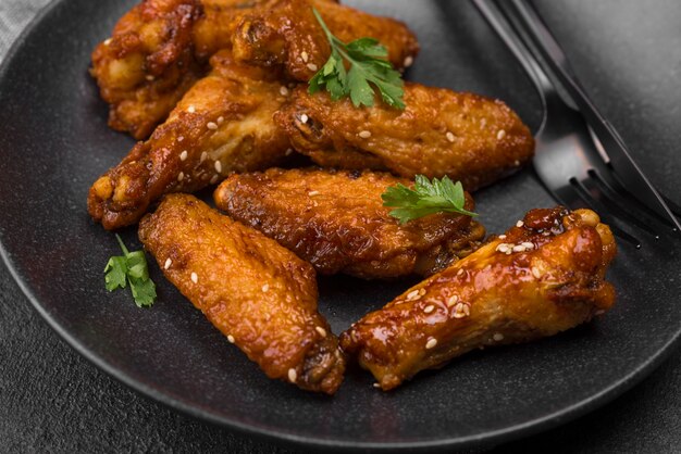 High angle of fried chicken parts on plate with cutlery