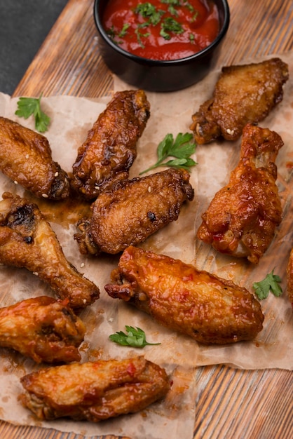 High angle of fried chicken parts with sauce