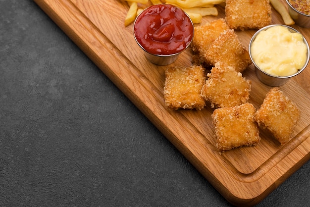 High angle of fried chicken with sauces and copy space