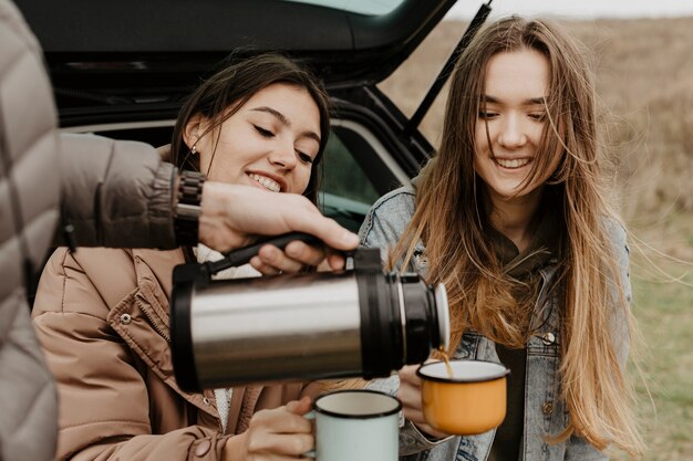 High angle friend pouring tea for the others