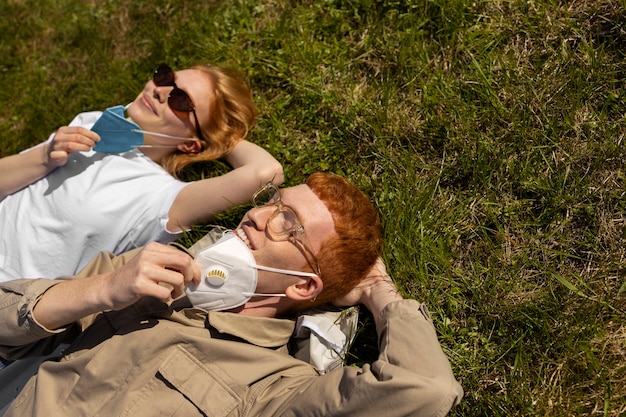 High angle friends laying on grass