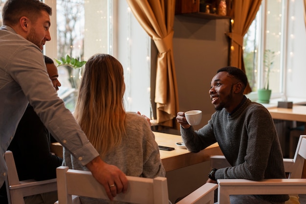 High angle friends at restaurant chatting