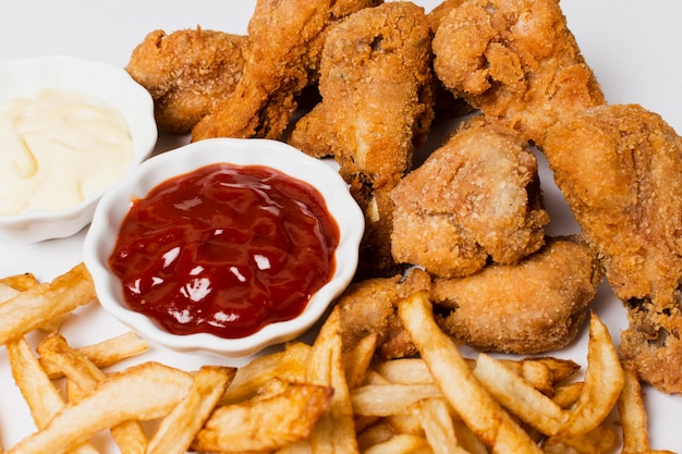 High angle of fries and fried chicken