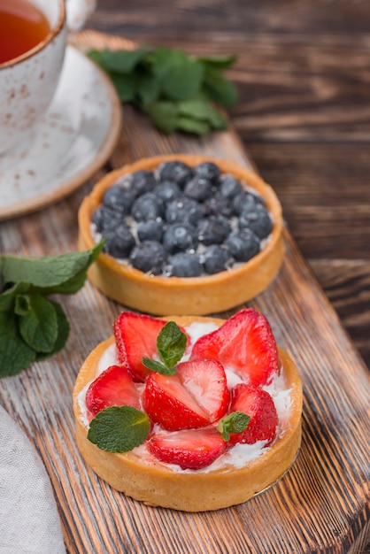 High angle of fruit tarts with strawberries and blueberries