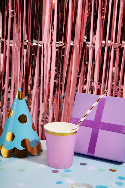 Free photo high angle gift, cup and party hat arrangement