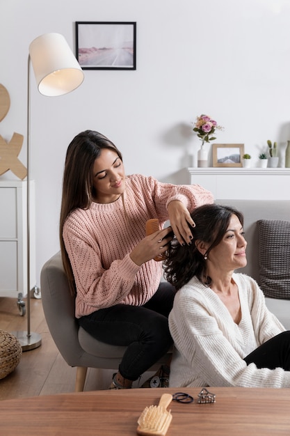 High angle girl braiding mom hair