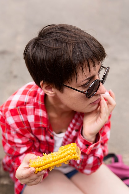 High angle girl eating corn