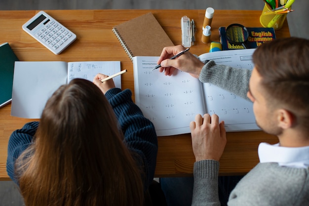 Foto gratuita ragazza dell'angolo alto che impara la matematica a scuola