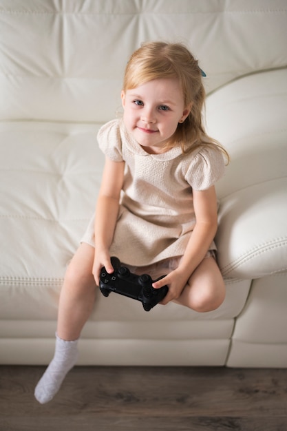 High angle girl playing with joystick 