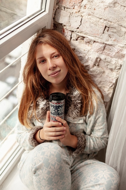 High angle girl posing with flask